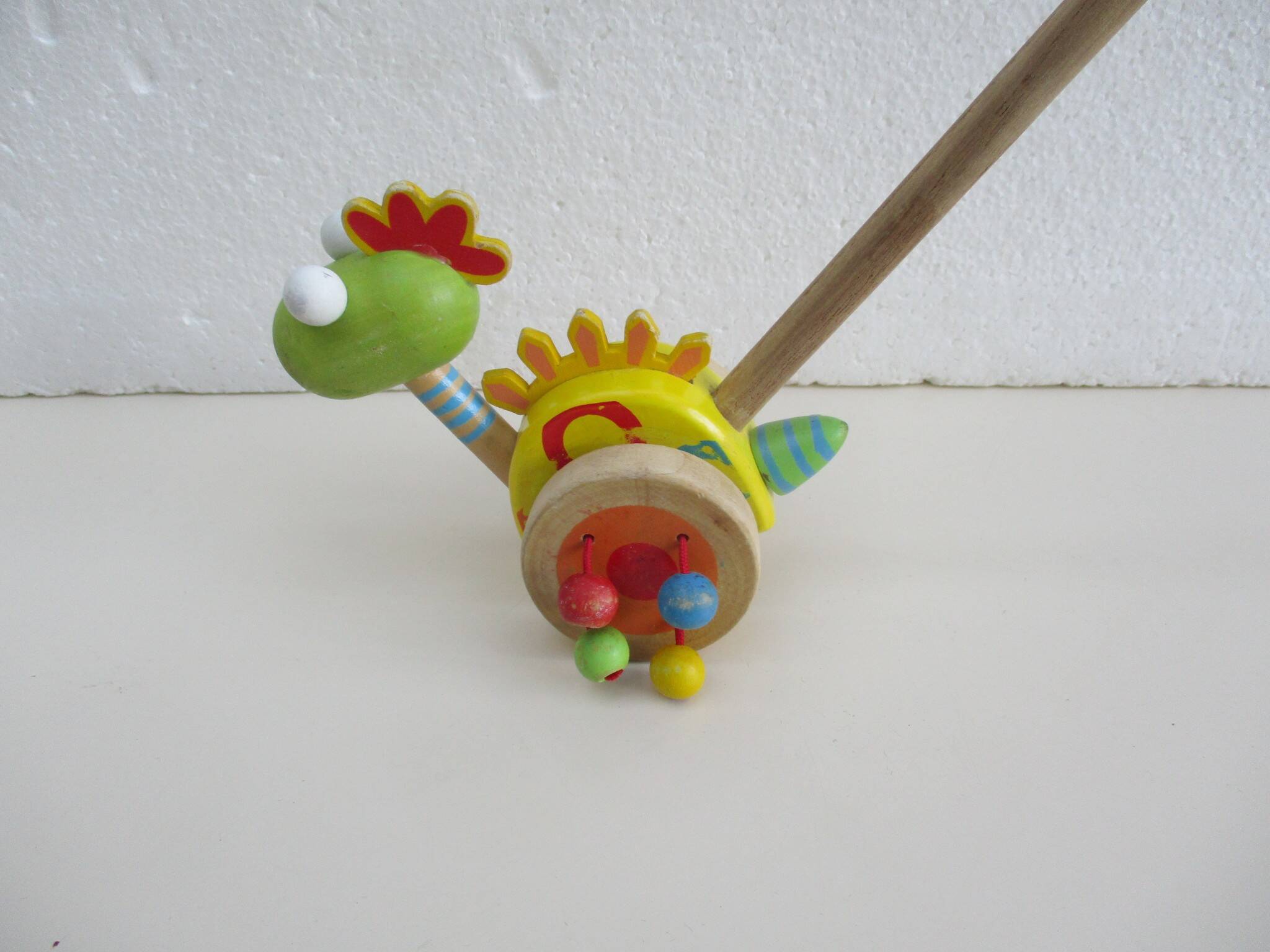 Push toy, wooden dinosaur. Brand: Bino