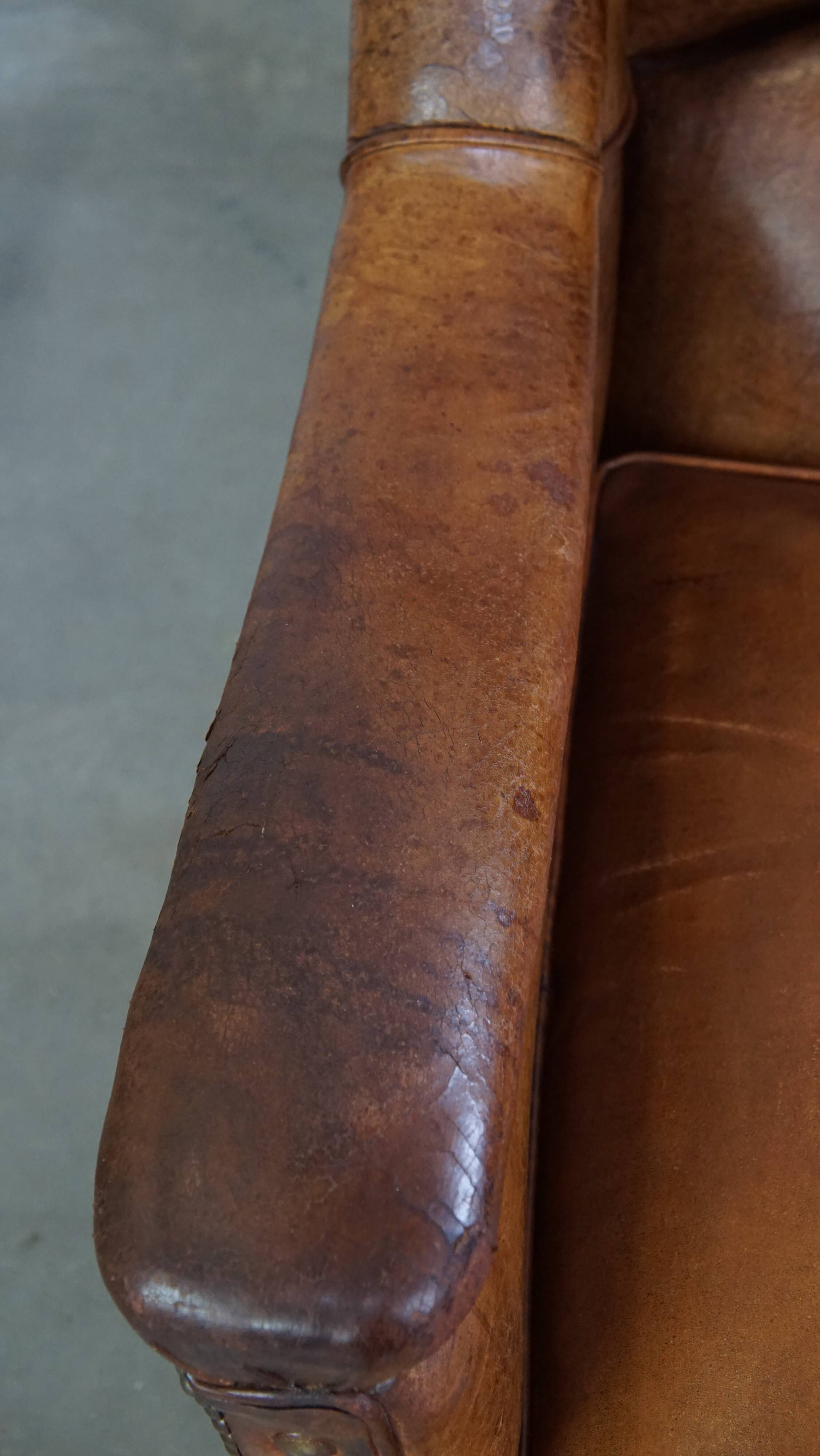 Fauteuil en cuir de mouton antique caractéristique avec de beaux détails et un design unique