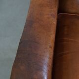 Characteristic antique sheepskin leather armchair with beautiful details and a unique design