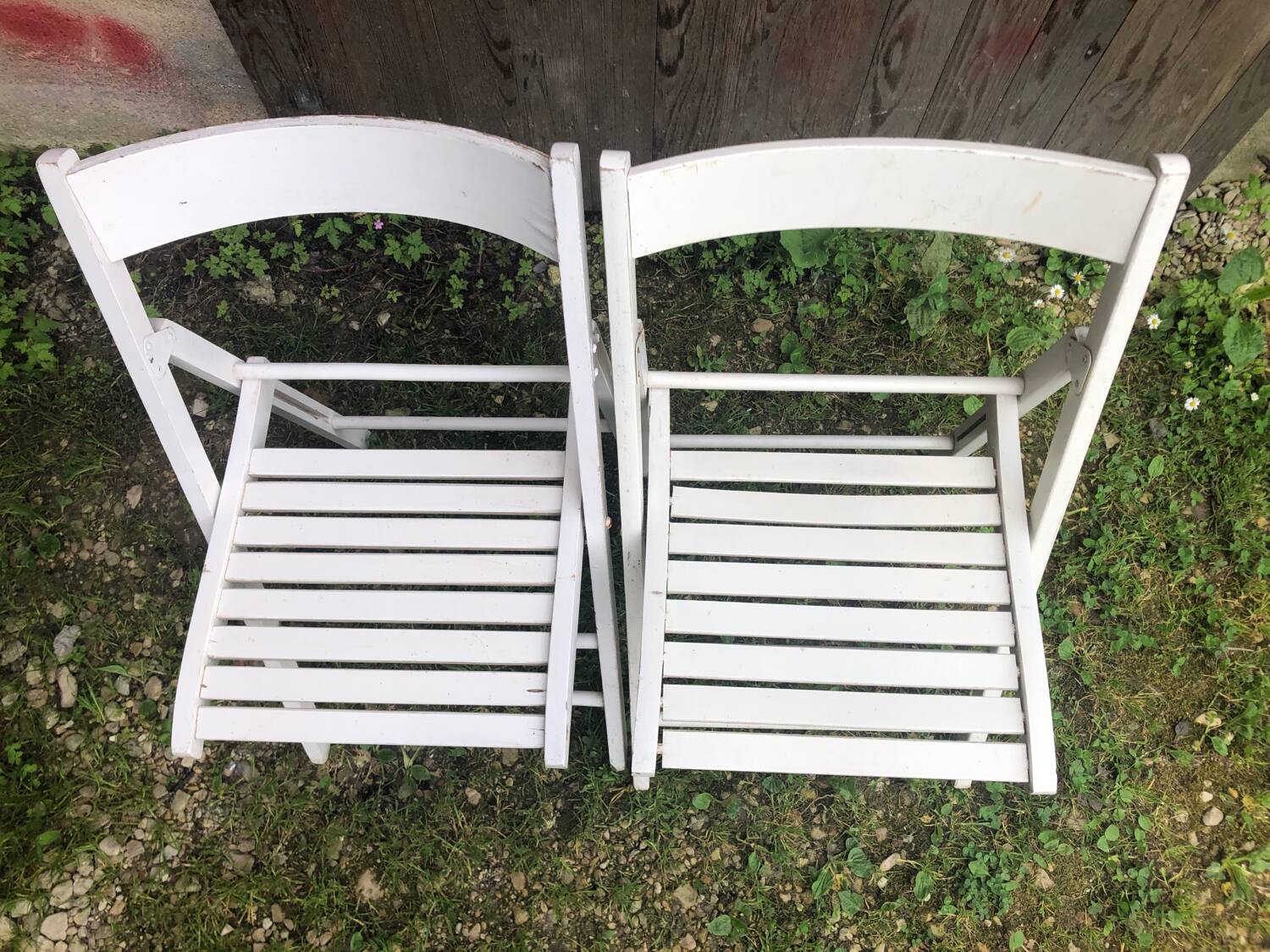 Pair of vintage white wooden folding chairs