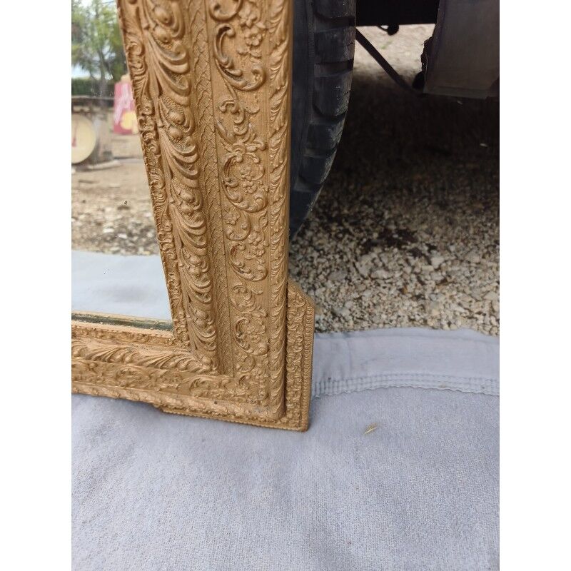 19th-century mirror in gilded wood and stucco.