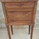 Old wooden bedside table on marble top