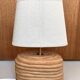 Oval table lamp in handcrafted ceramic with draped effect.