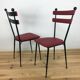 Pair of 1950s chairs in metal and red faux leather, Gueden-Adnet style.