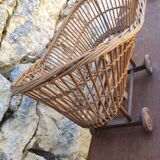 Old rattan cradle on wheels