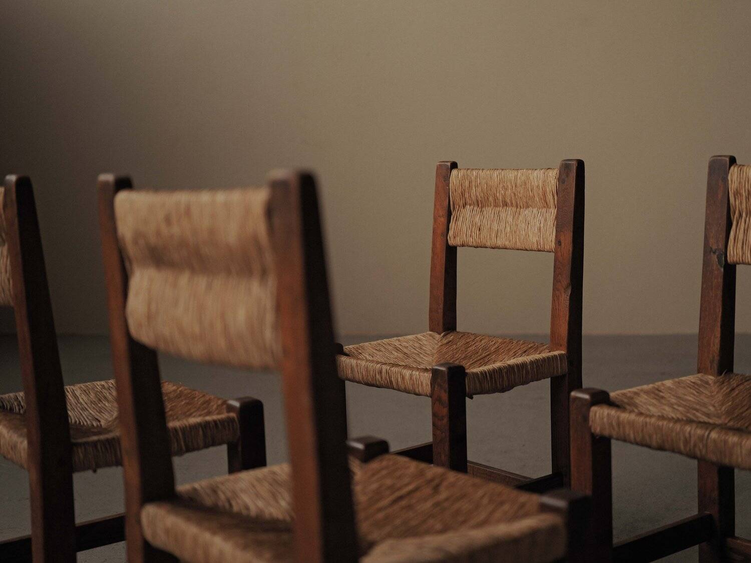 Set of four modernist chairs in oak and straw, France, circa 1960.