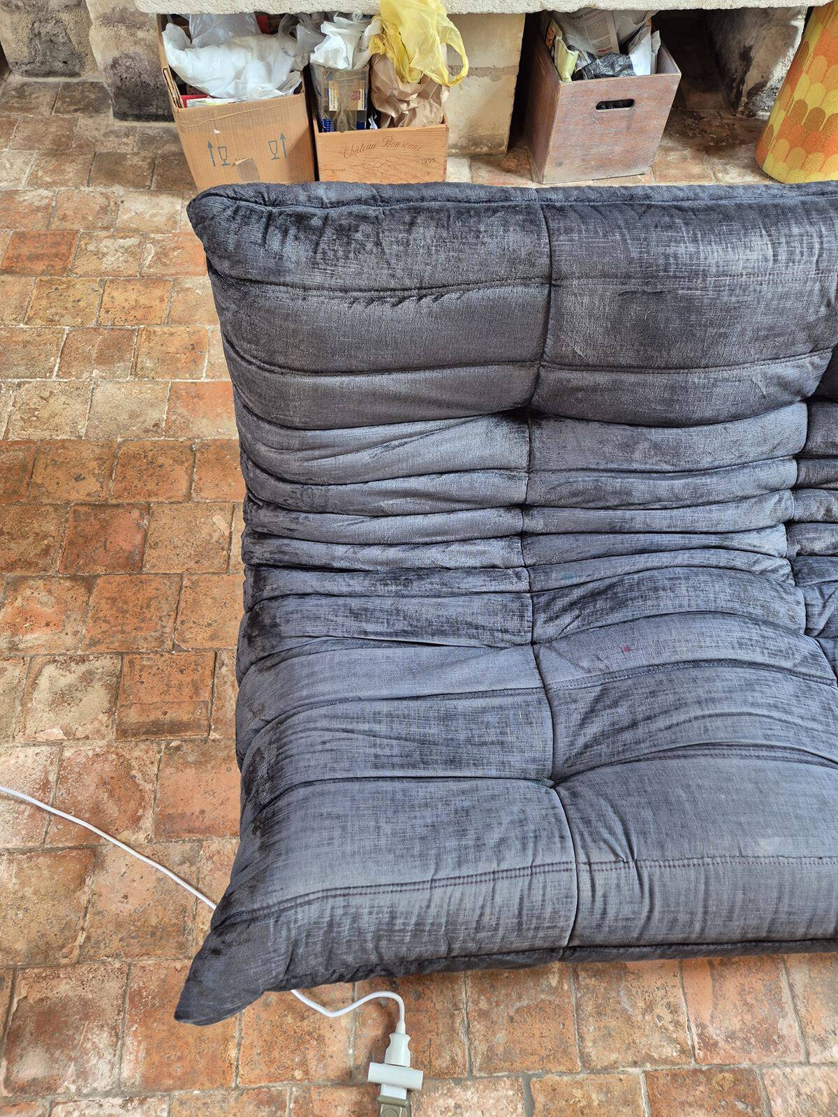 Togo sofa by Ligne Roset and its pouf from the 1970s.
