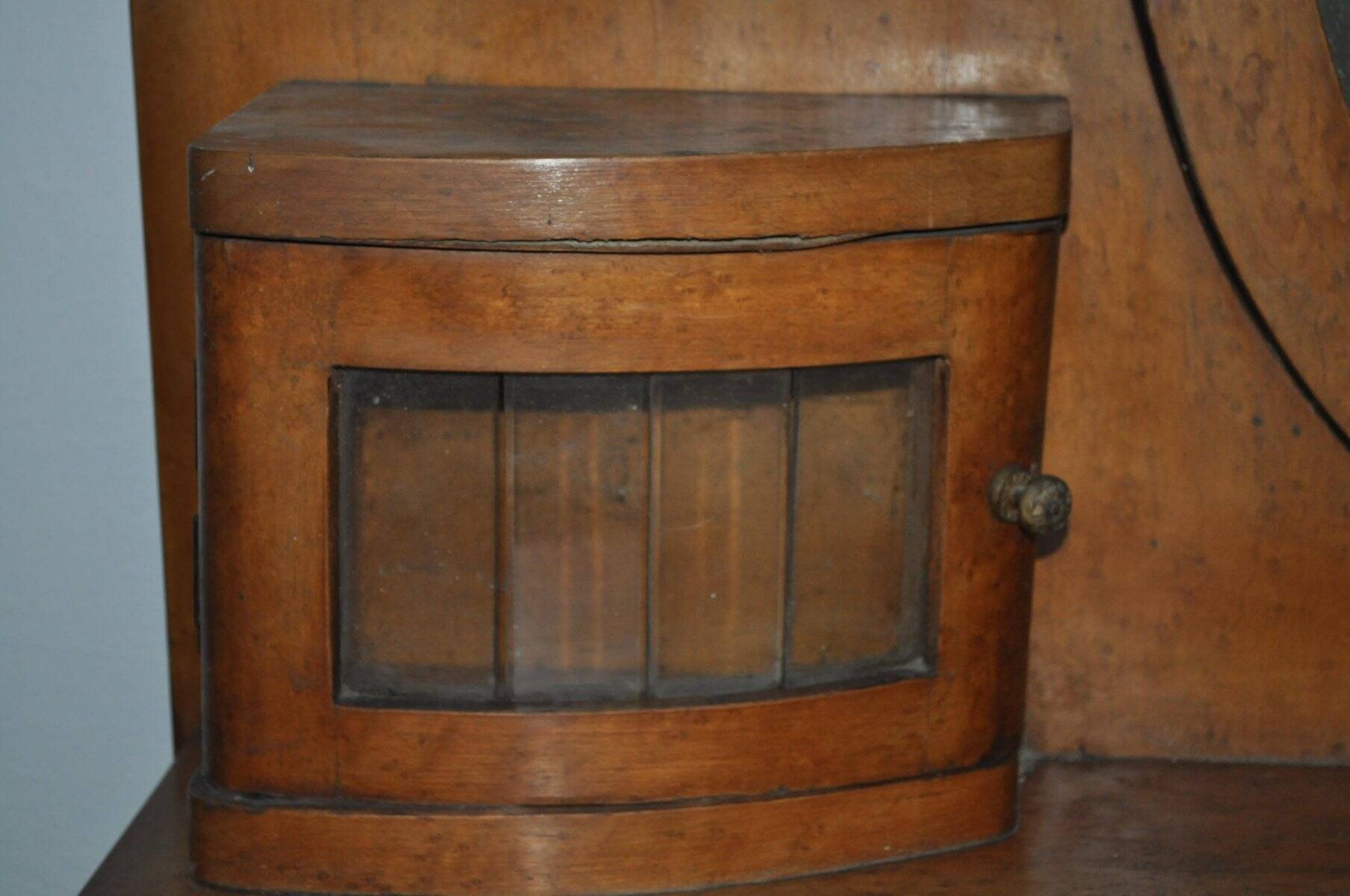 Large vintage brown wooden dressing table with an oval mirror and built-in storage.