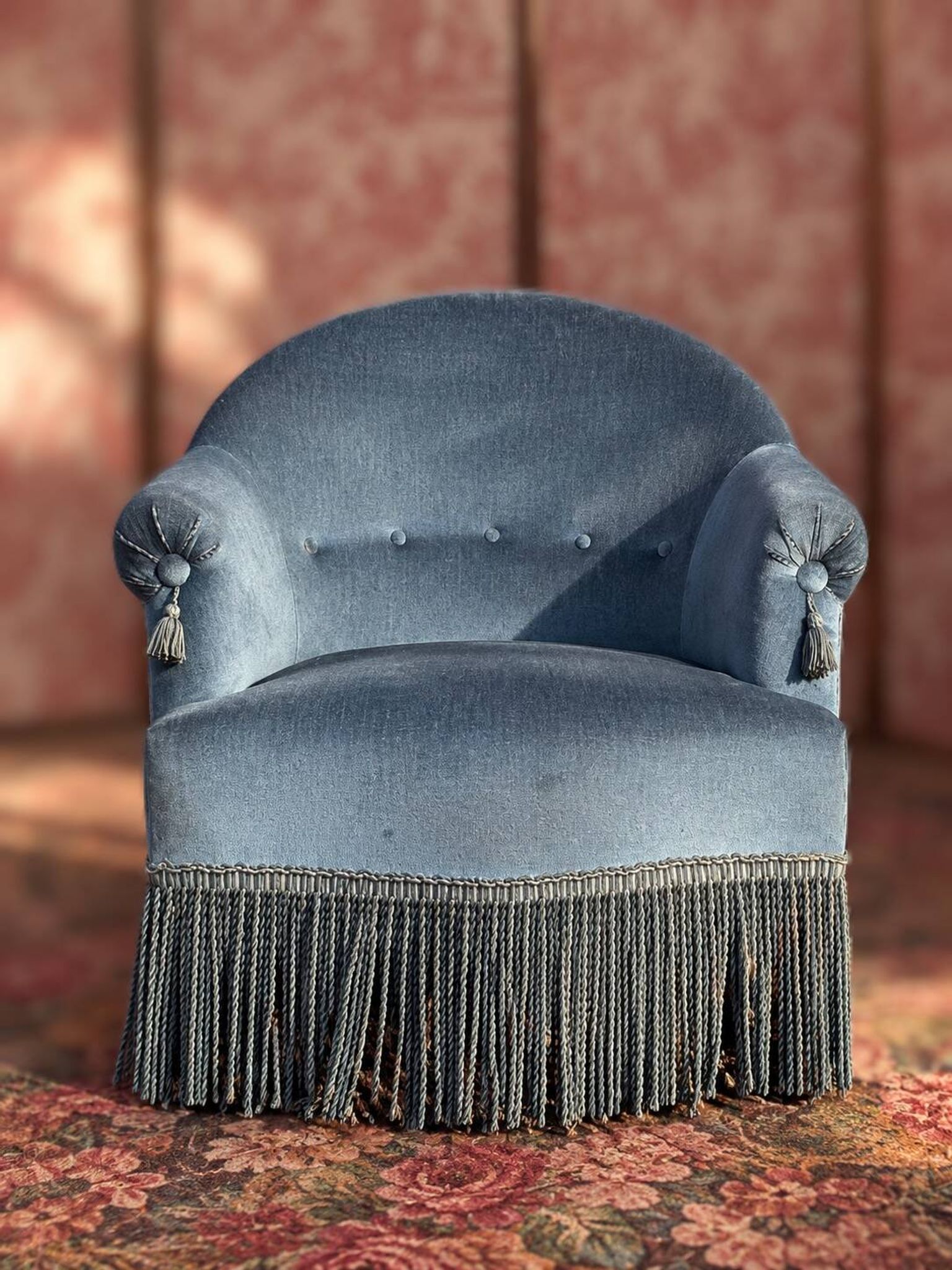 Vintage blue velvet frog chair, a timeless comfortable piece.