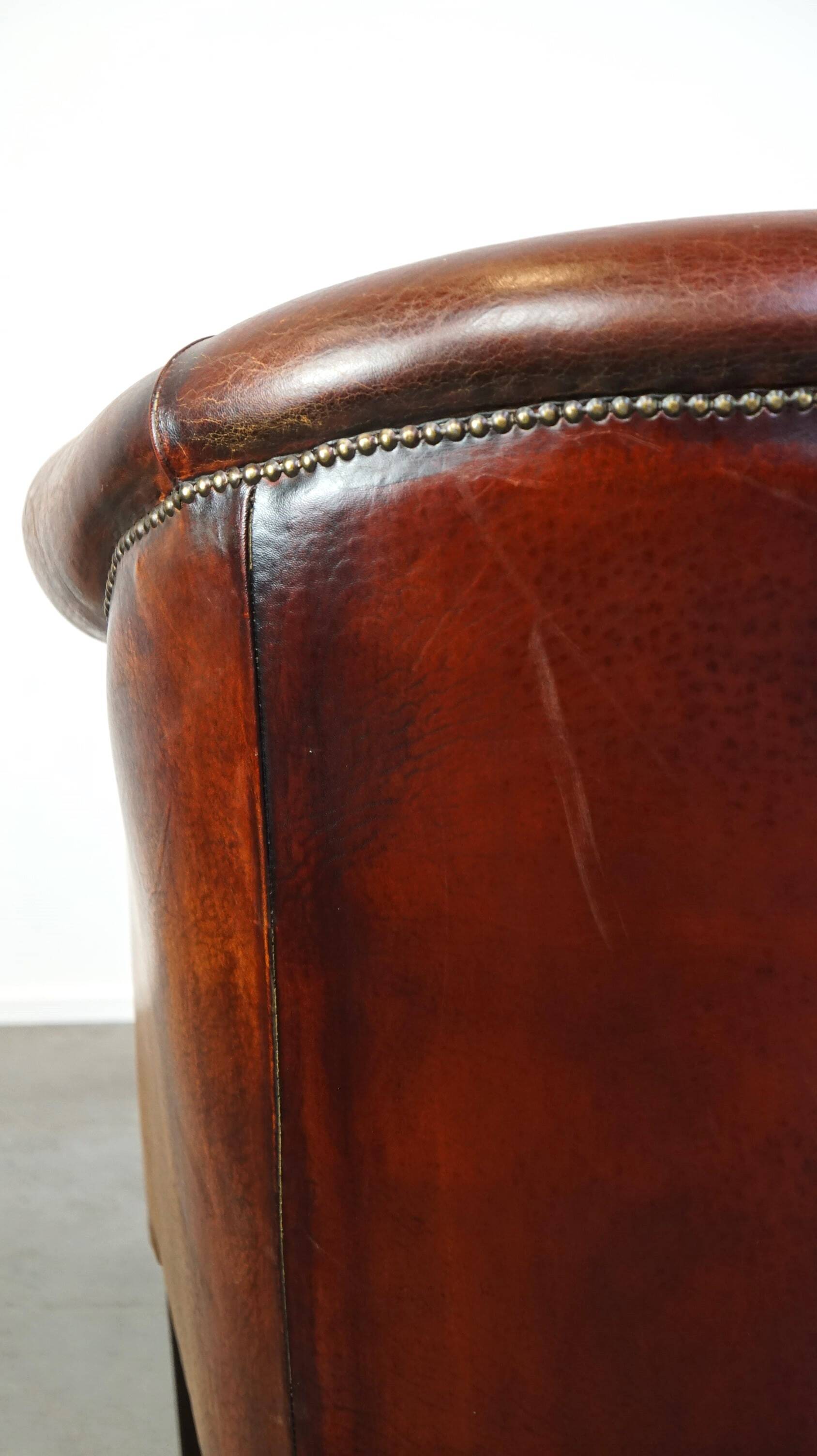 Very luxurious dark brown sheepskin club chair with a more than beautiful patina