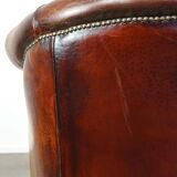 Very luxurious dark brown sheepskin club chair with a more than beautiful patina