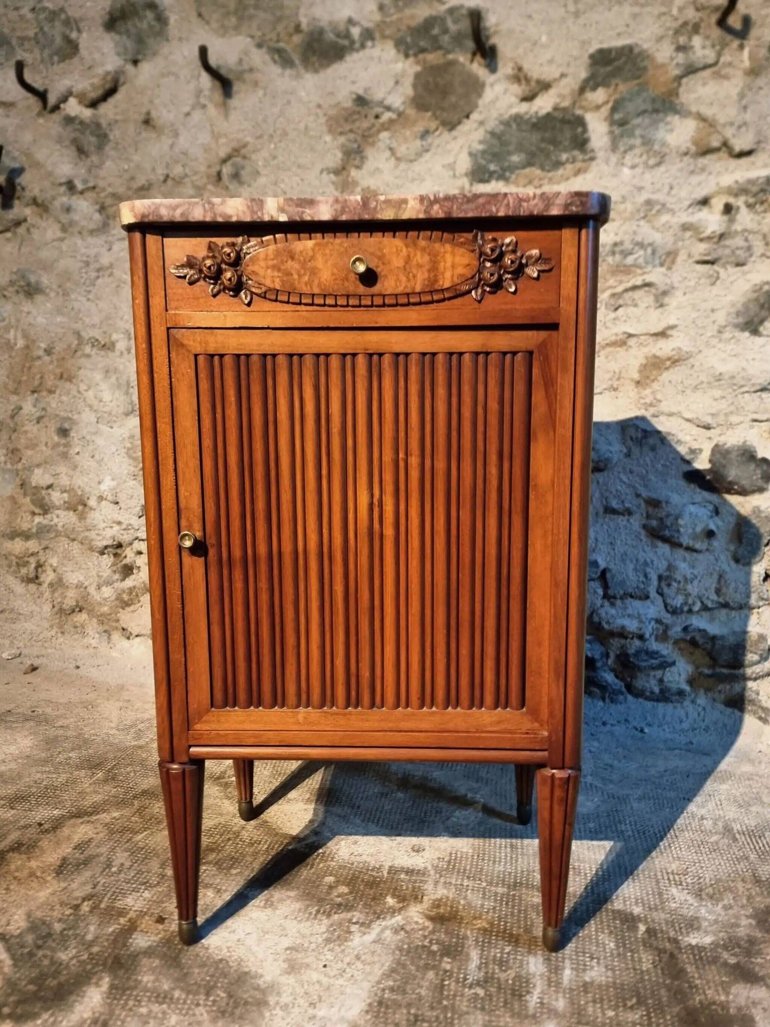 French antique bedside table in walnut with a marble top and porcelain interior, early 20th century.