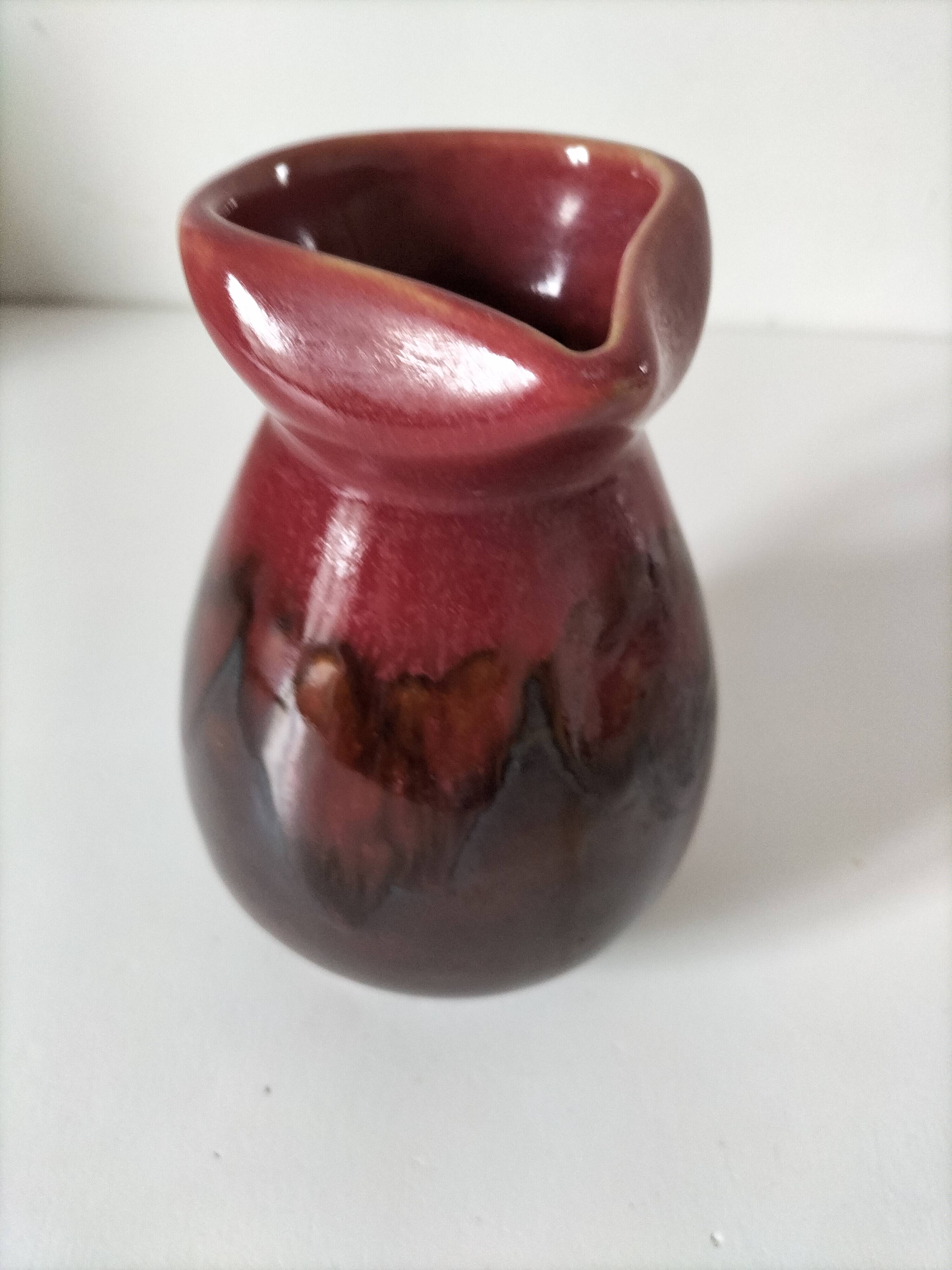 Vintage pitcher in raspberry red and chocolate flamed ceramic.