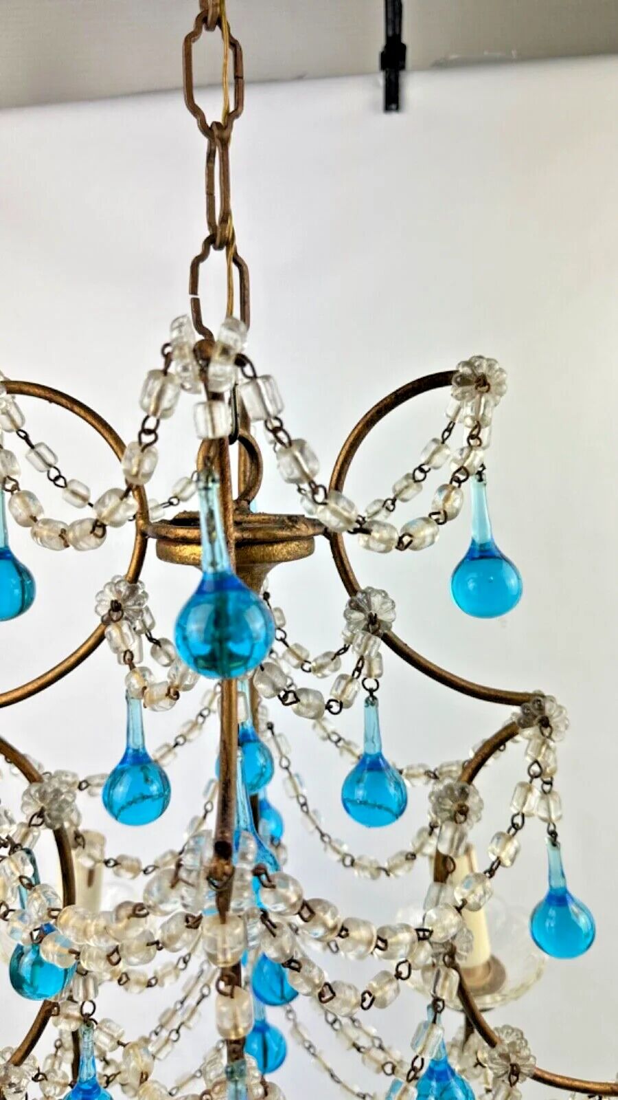 Italian chandelier with blue beads and gilded wood.