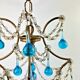 Italian chandelier with blue beads and gilded wood.