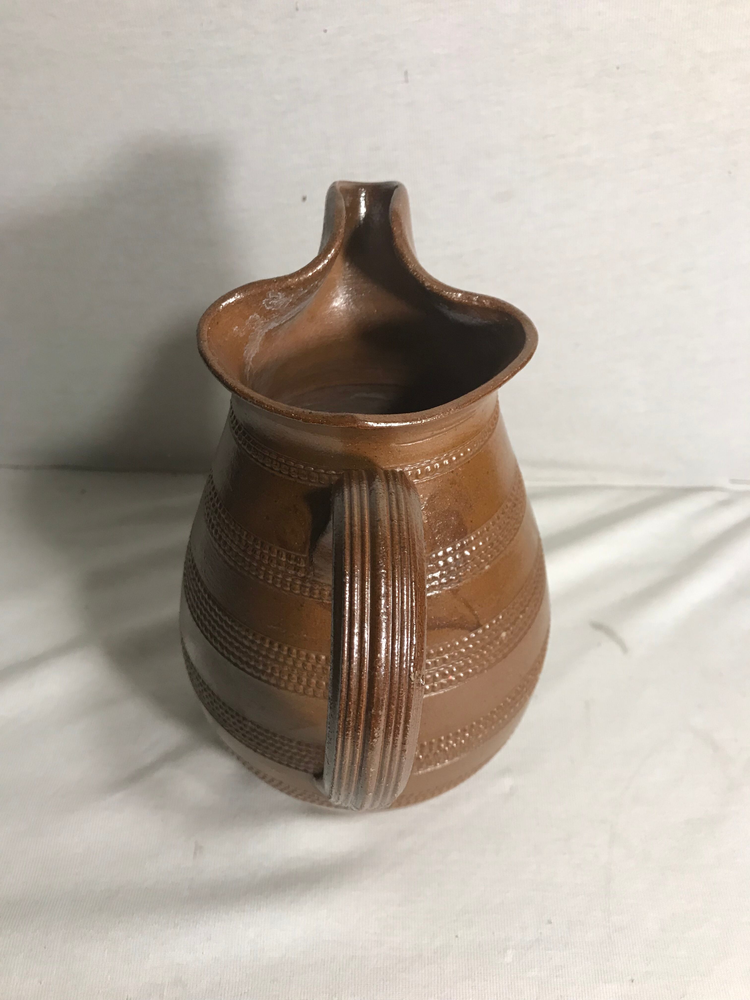 Old brown glazed ceramic jug from the 1950s