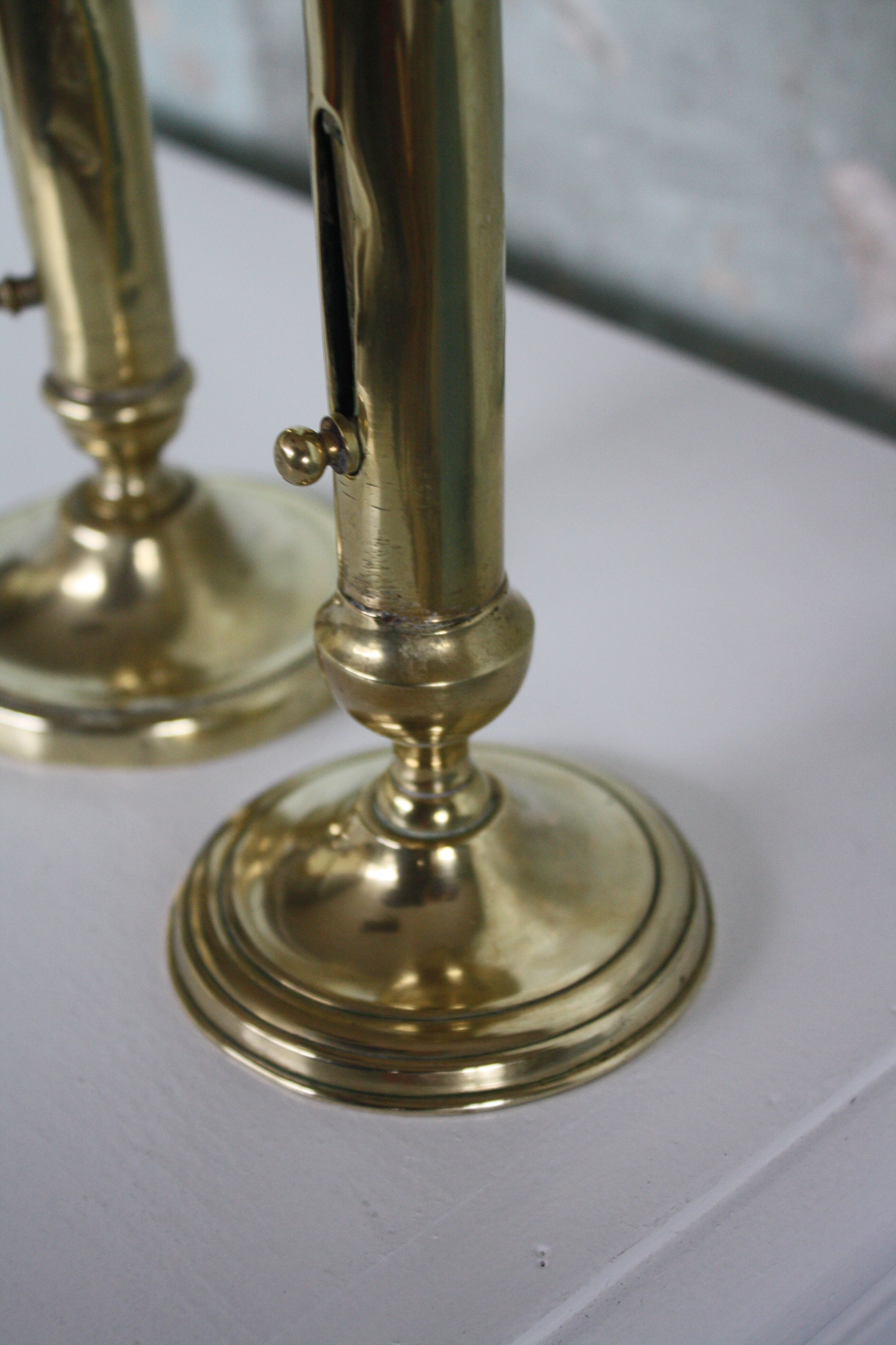 Pair of brass push-up candlesticks