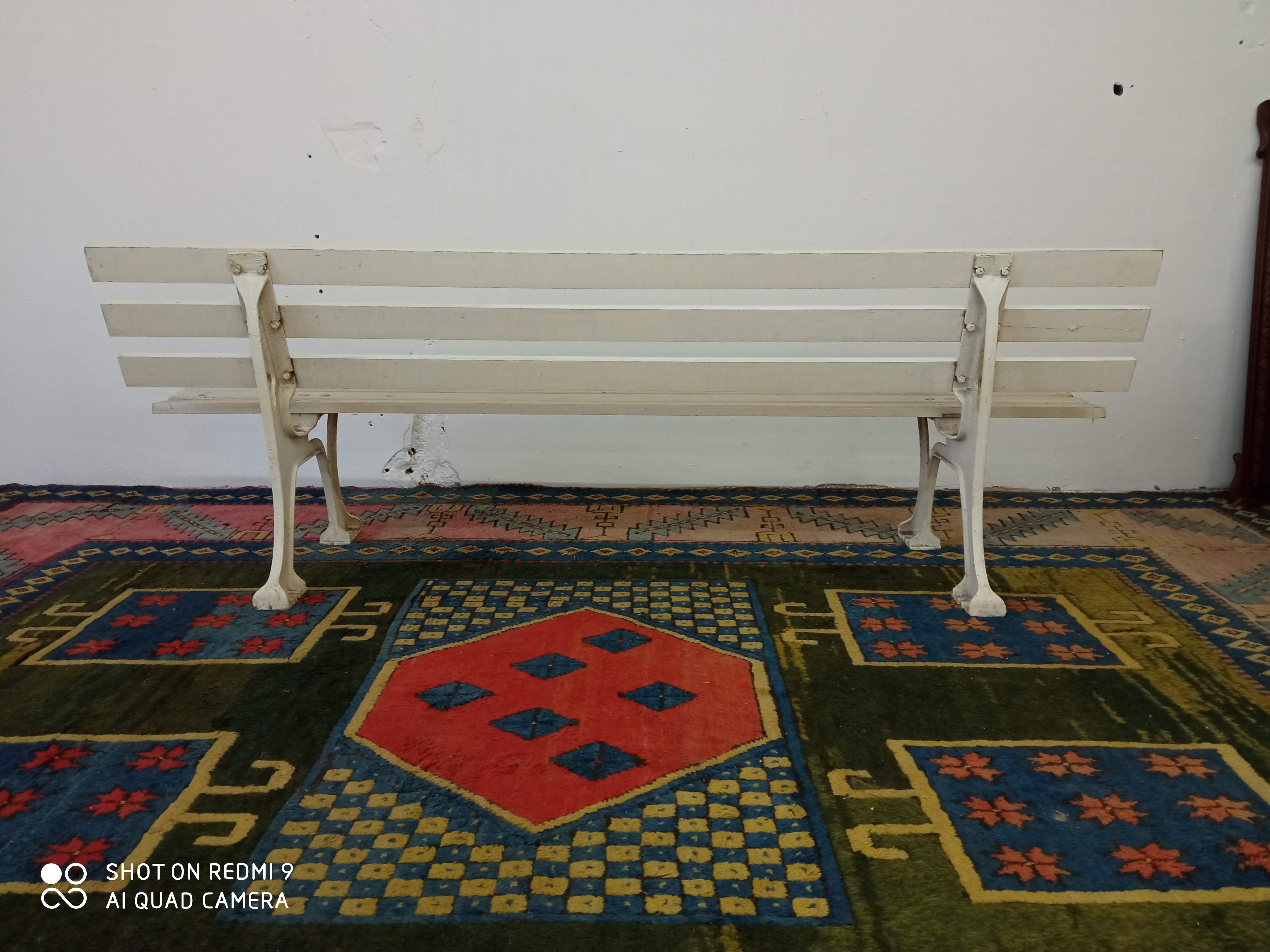 Wooden garden bench and old cast iron