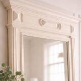 Antique bevelled mirror, frame in pearl grey patinated wood.