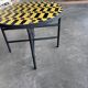 Round coffee table in yellow and black zellige, Moroccan graphic pattern.