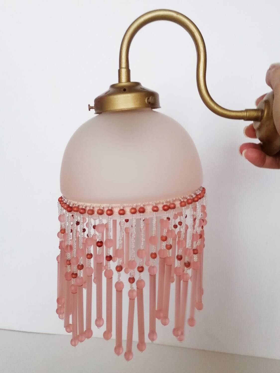 Pink glass wall lamp with garland of pearls