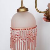 Pink glass wall lamp with garland of pearls