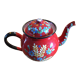 Red enamel teapot with hand-painted floral decoration