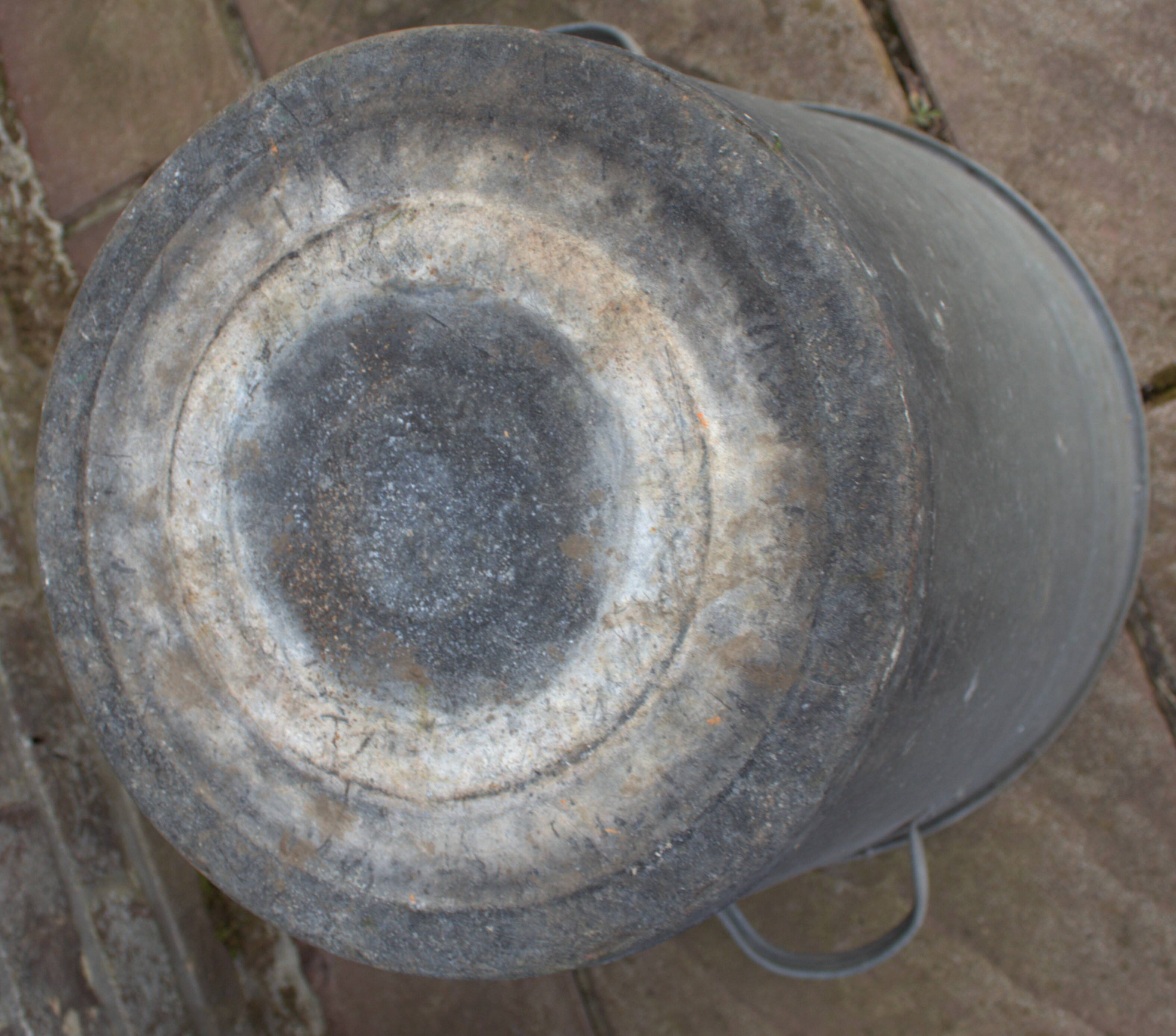 Old galvanized zinc trash can with lid