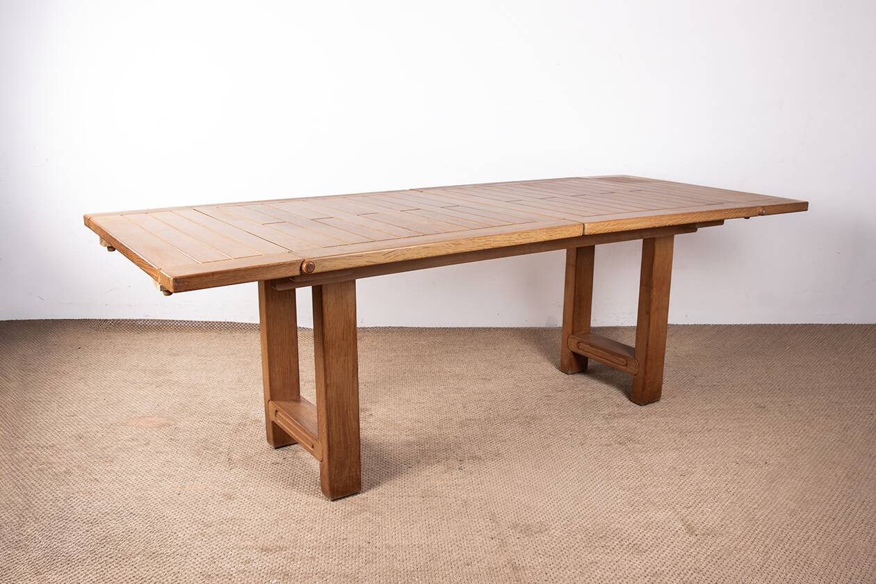 Large extendable dining table in solid oak by Guillerme and Chambron.