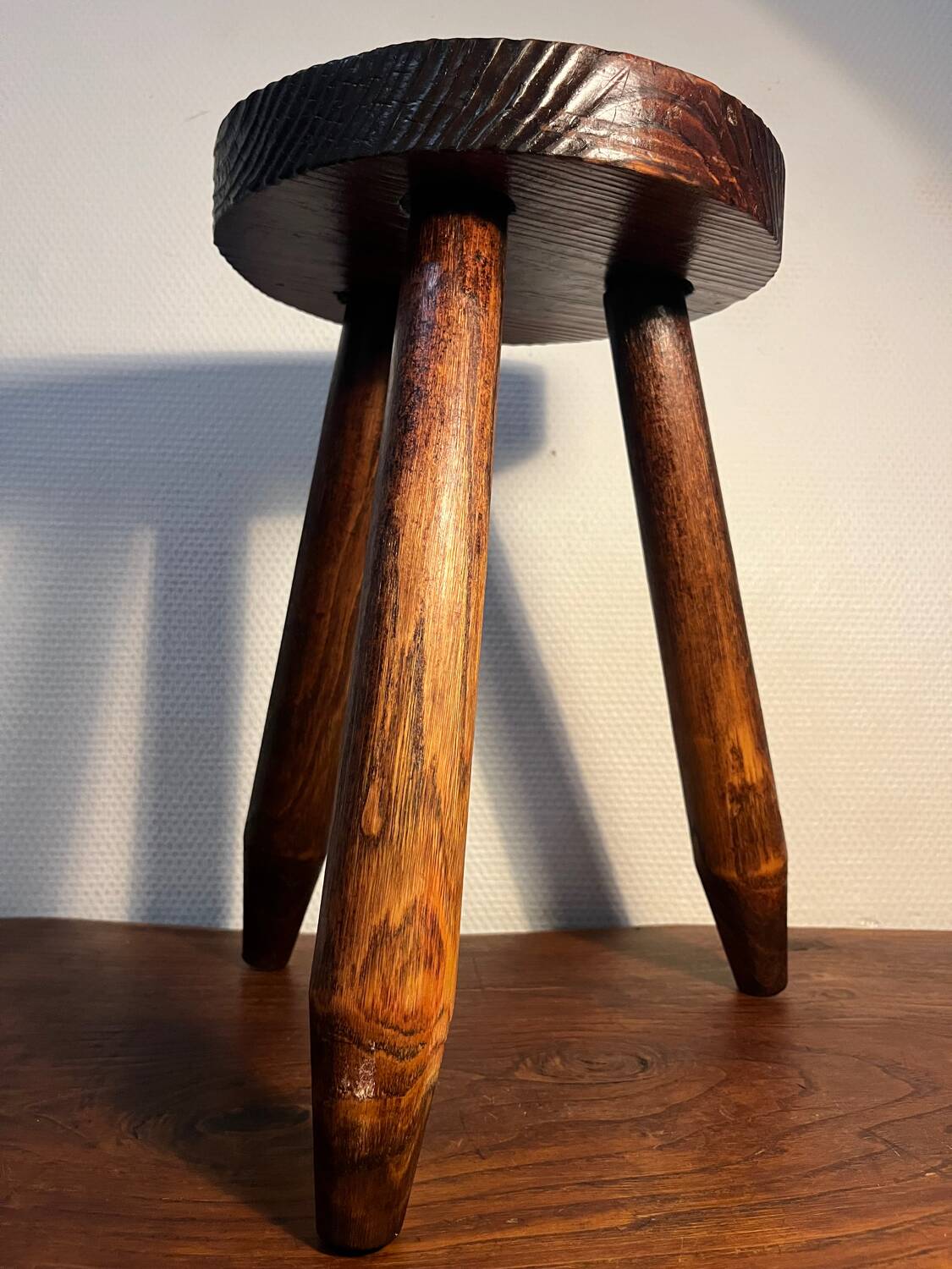 Round wooden tripod stool