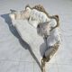 A white and gold tufted beech wood sofa in Louis XV style.