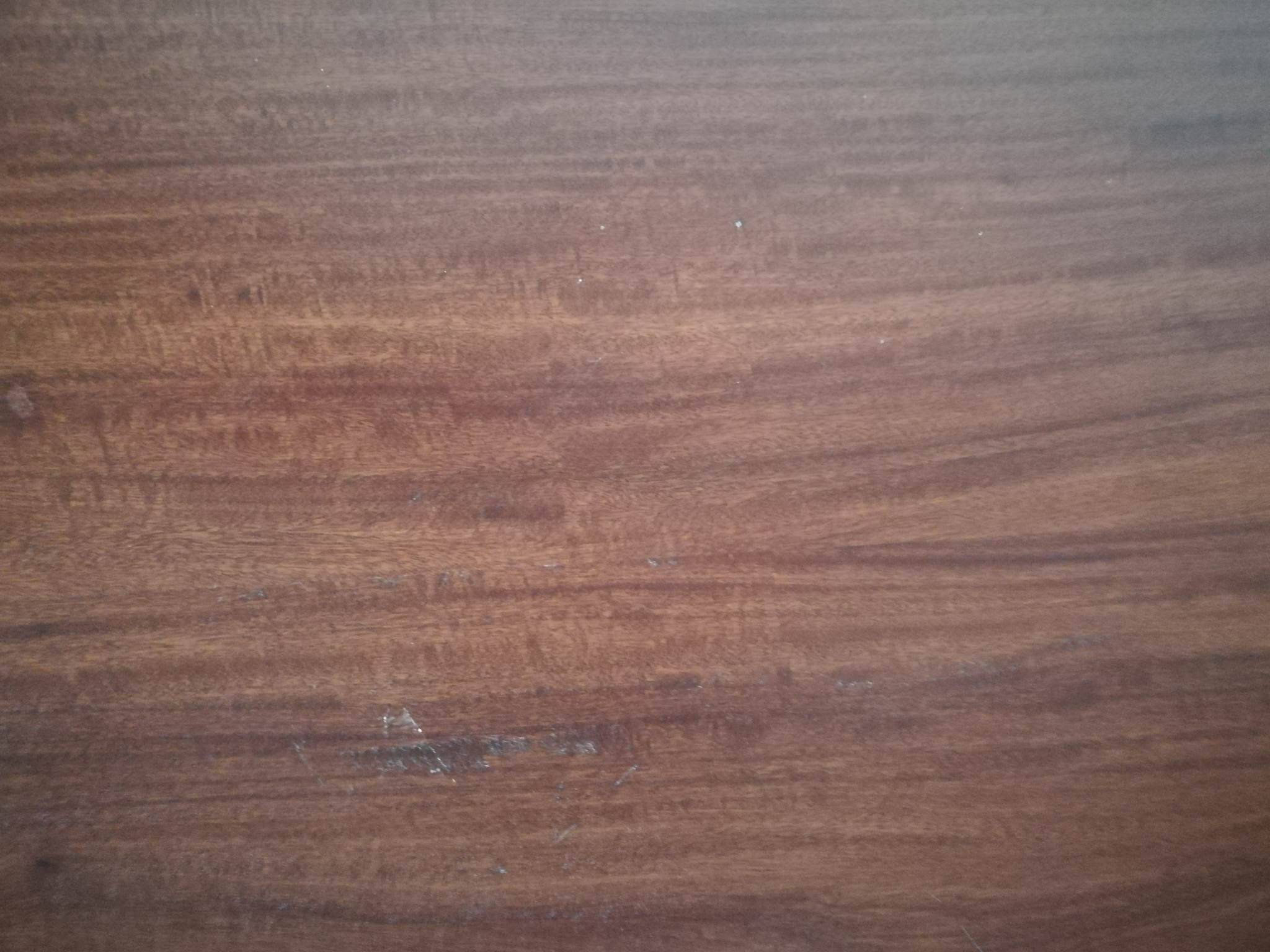 Round wooden table with thin legs