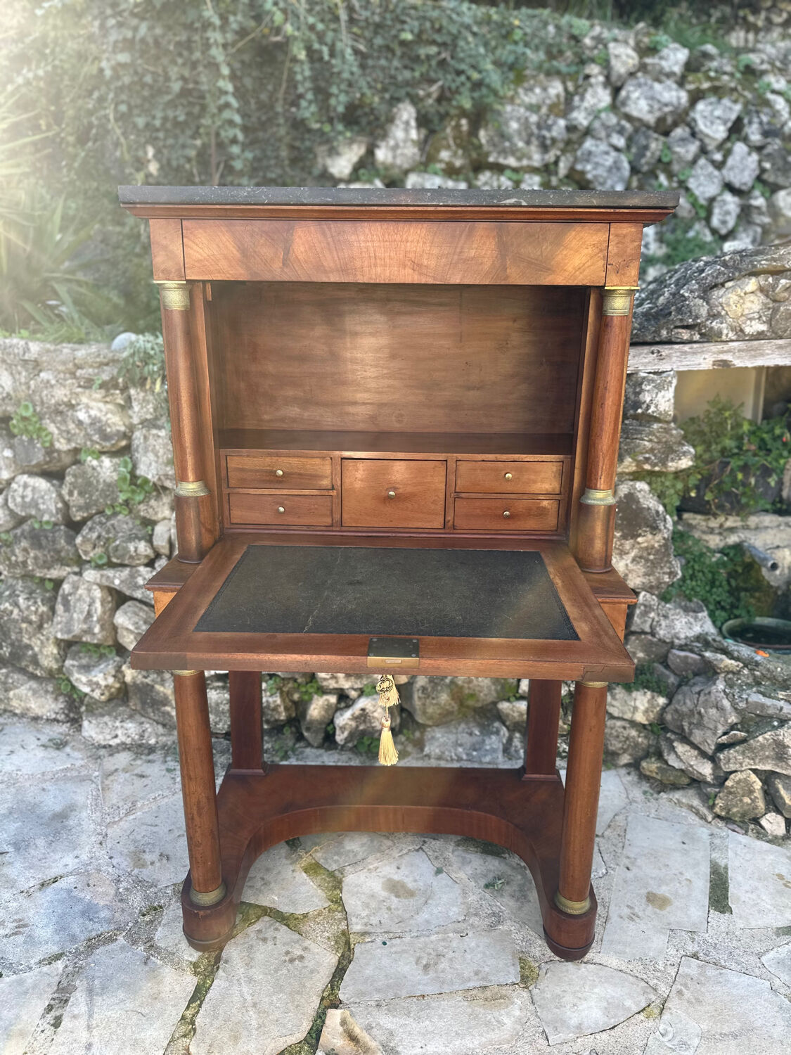 A small piece of Bonheur du jour with detached columns in Empire-era mahogany.