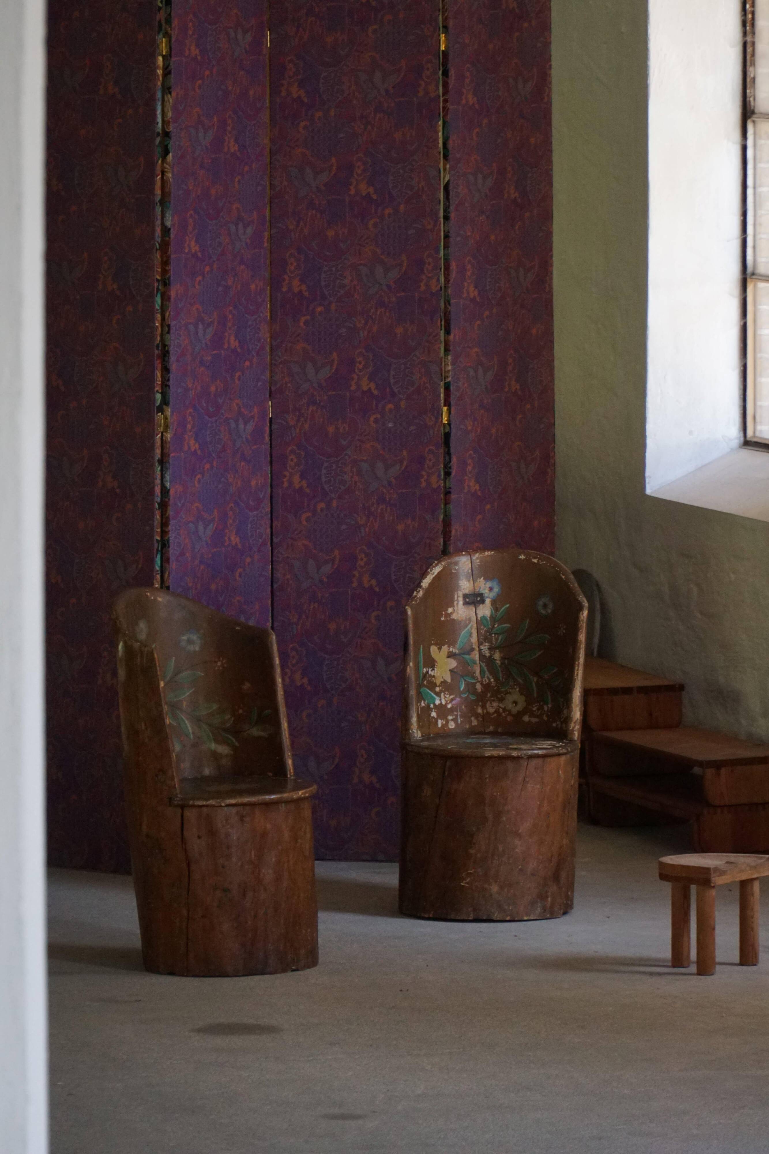 Pair of Swedish folk art stump chairs, decorated with painted floral motifs, late 19th century.