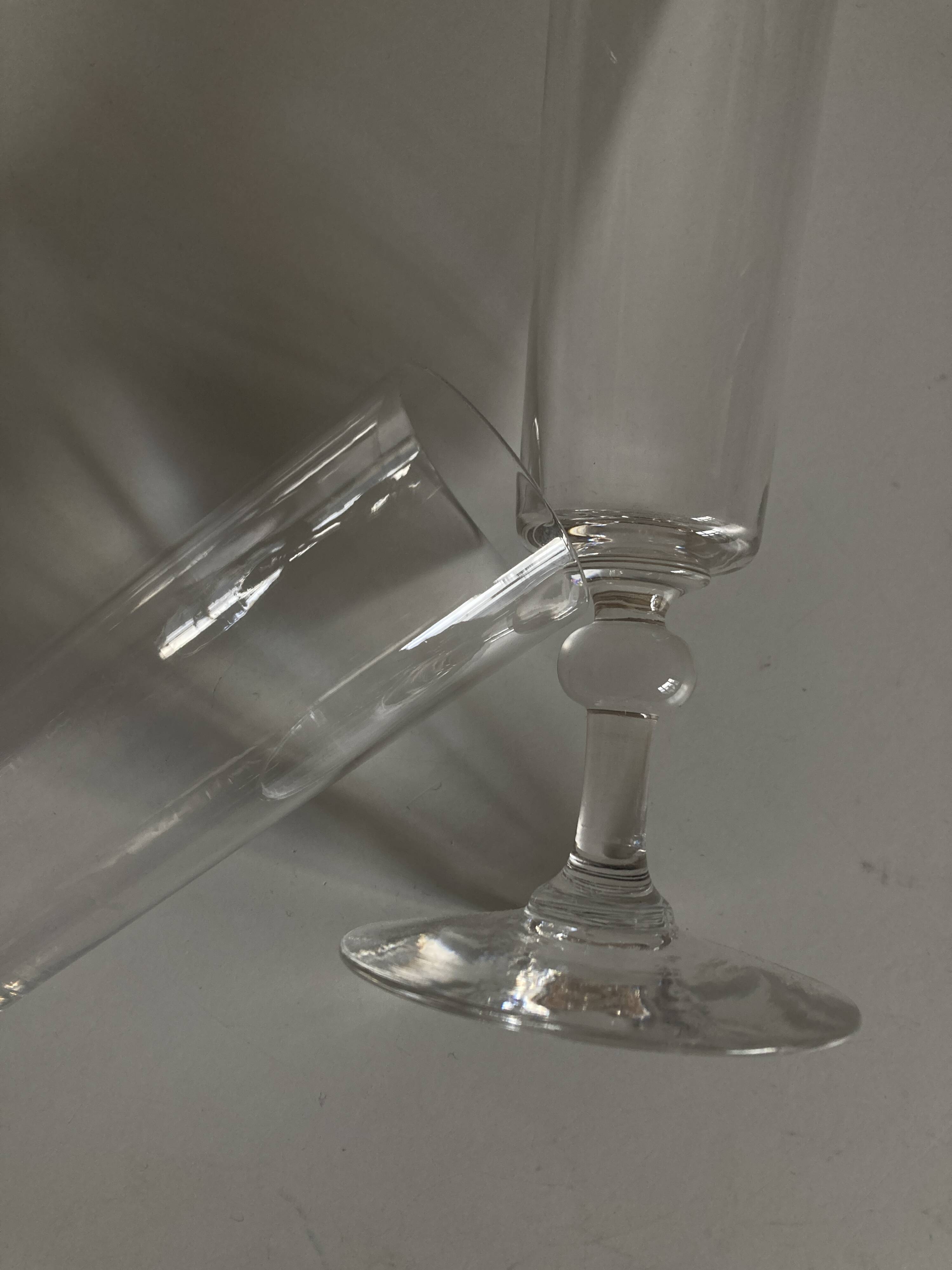Pair of crystal champagne flutes with a button foot, 1960.