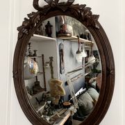 Antique oval mirror in carved wood and Louis XVI style knot