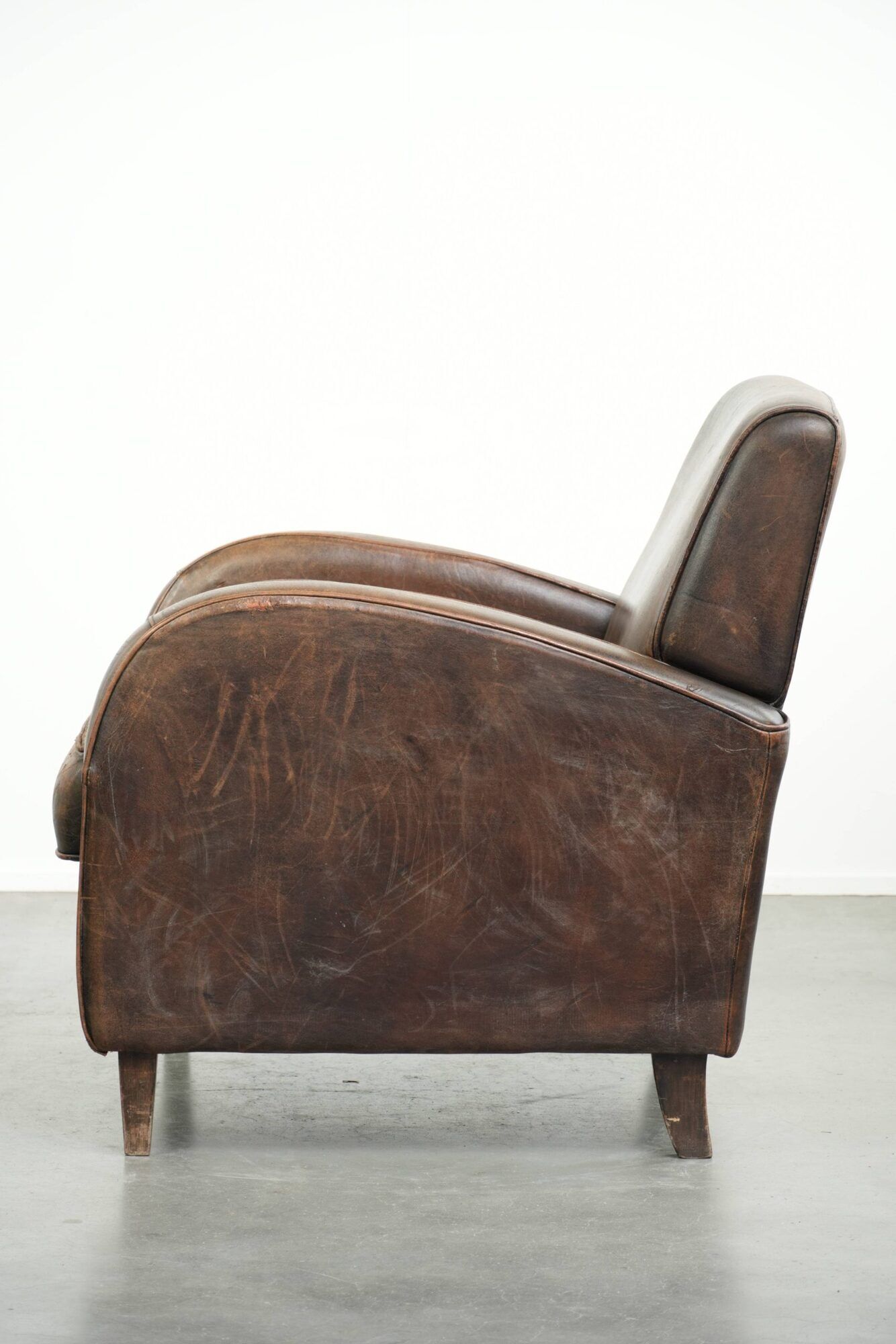 Comfortable sheepskin armchair with matching piping and a timeless look