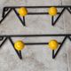 Two vintage metal and wood ball coat racks