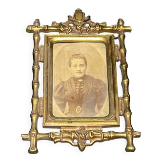 Old photograph of a woman in a brass frame