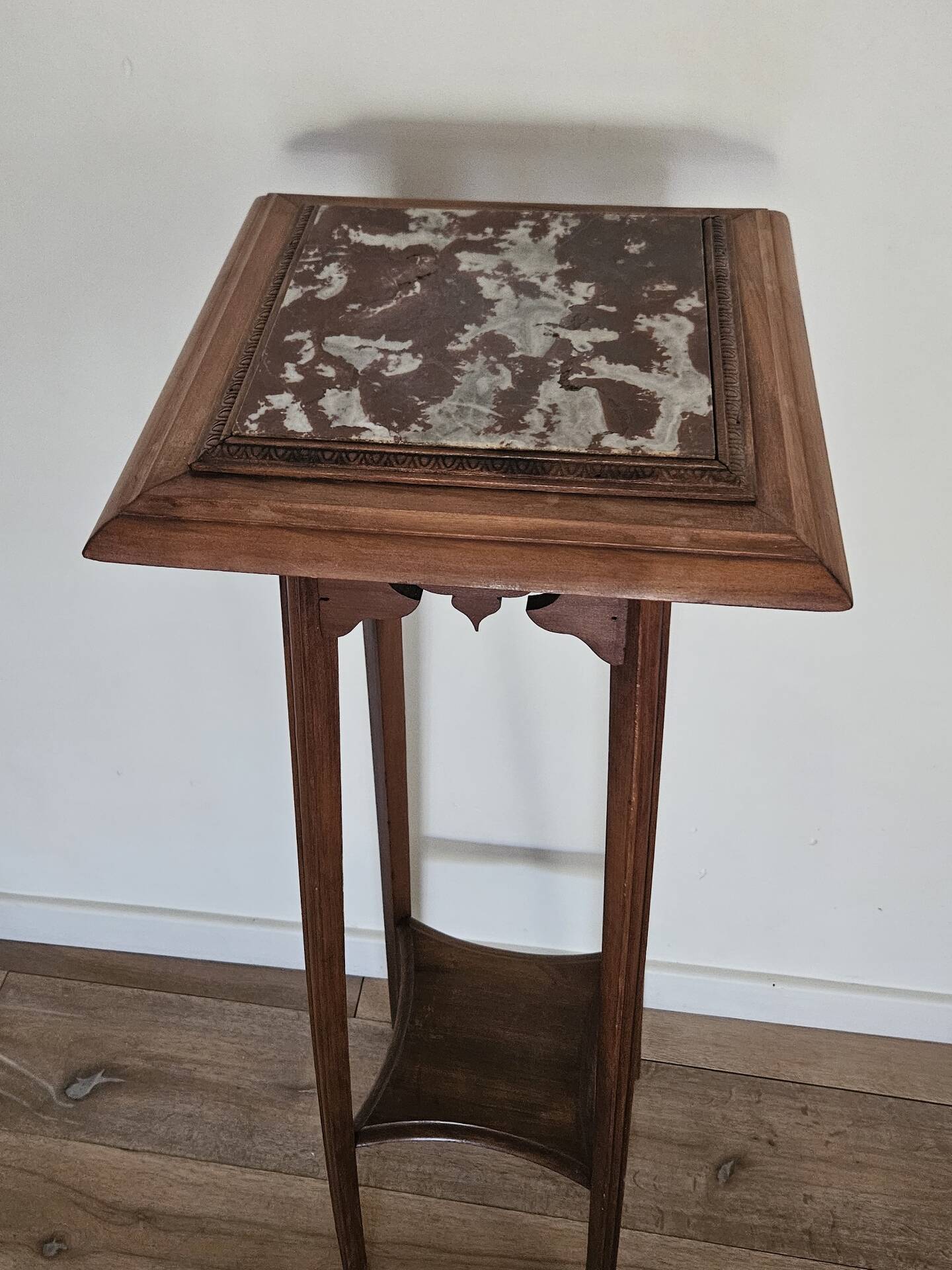 High plant stand in carved wood and Art Nouveau marble.