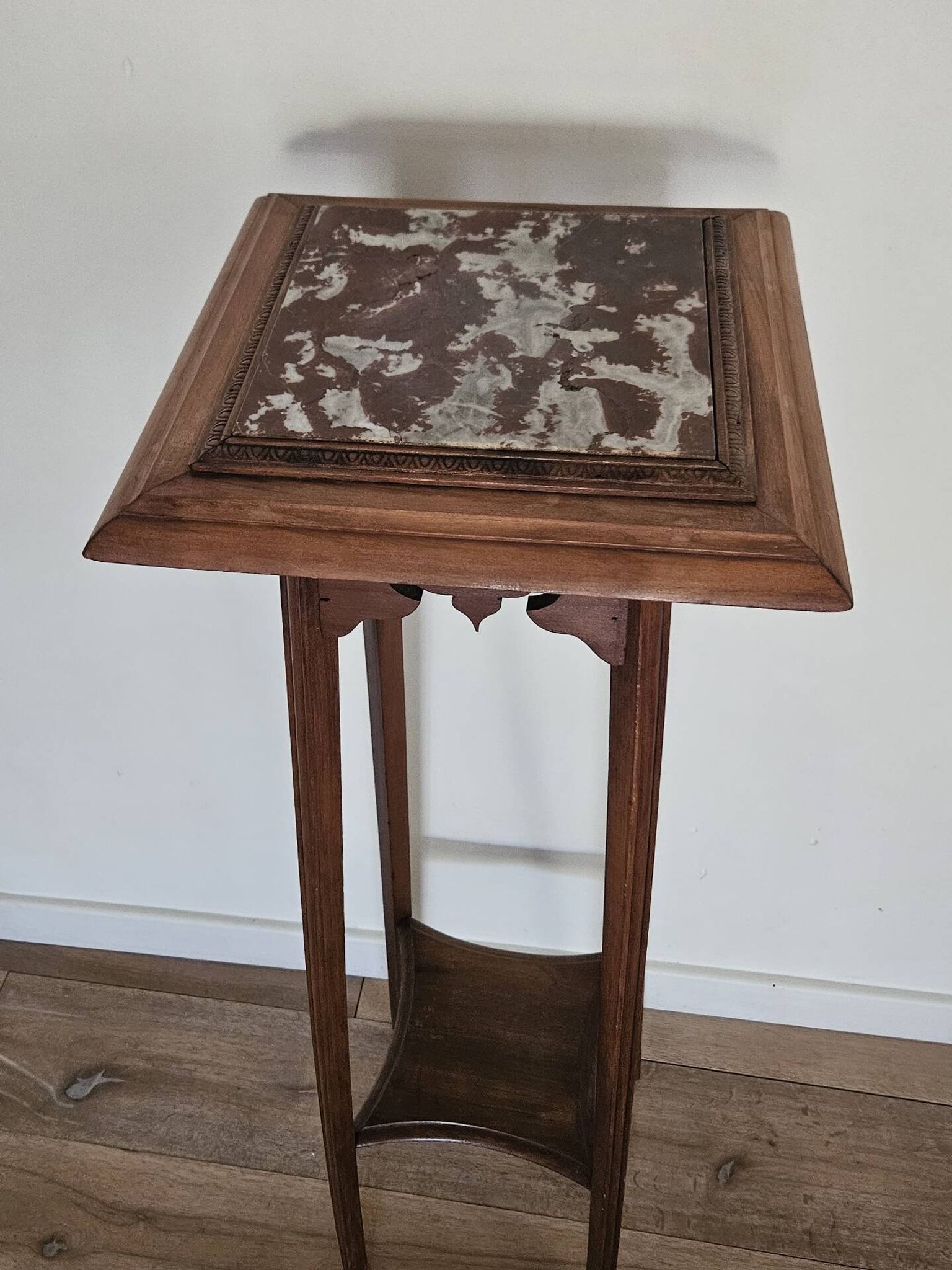 High plant stand in carved wood and Art Nouveau marble.