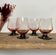 4 pink glasses with black stems
