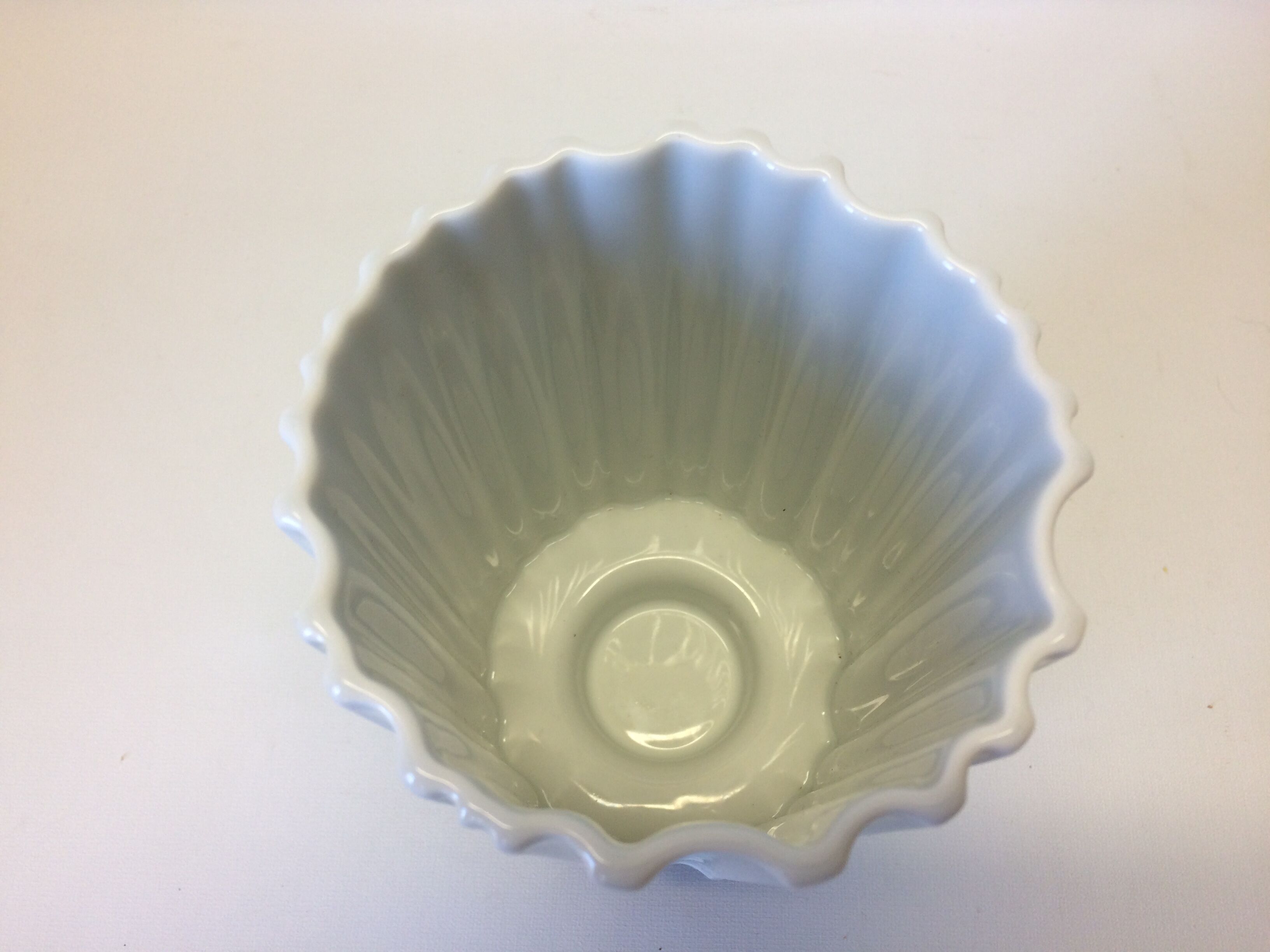 White vase on wooden base