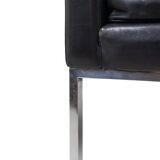 Pair of armchairs in black leather and chrome metal. 1970s.