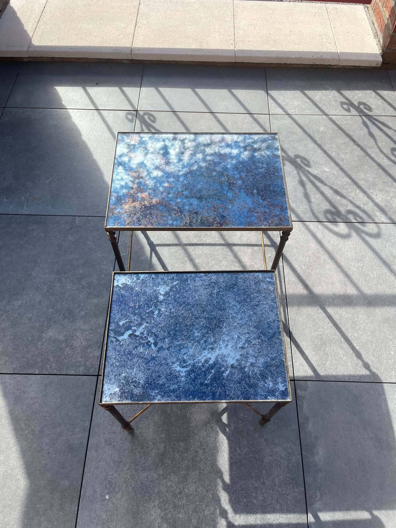 Pair of vintage nesting tables in gilded bronze and oxidised blue mirror, style