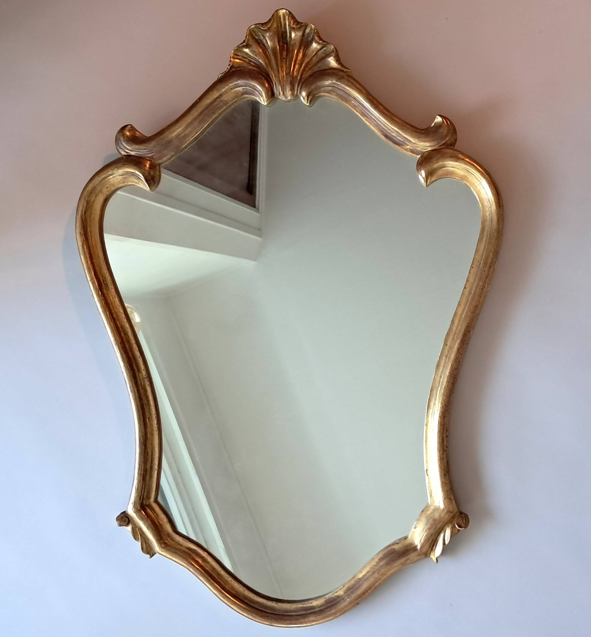 1950s rococo mirror in gilded stucco.