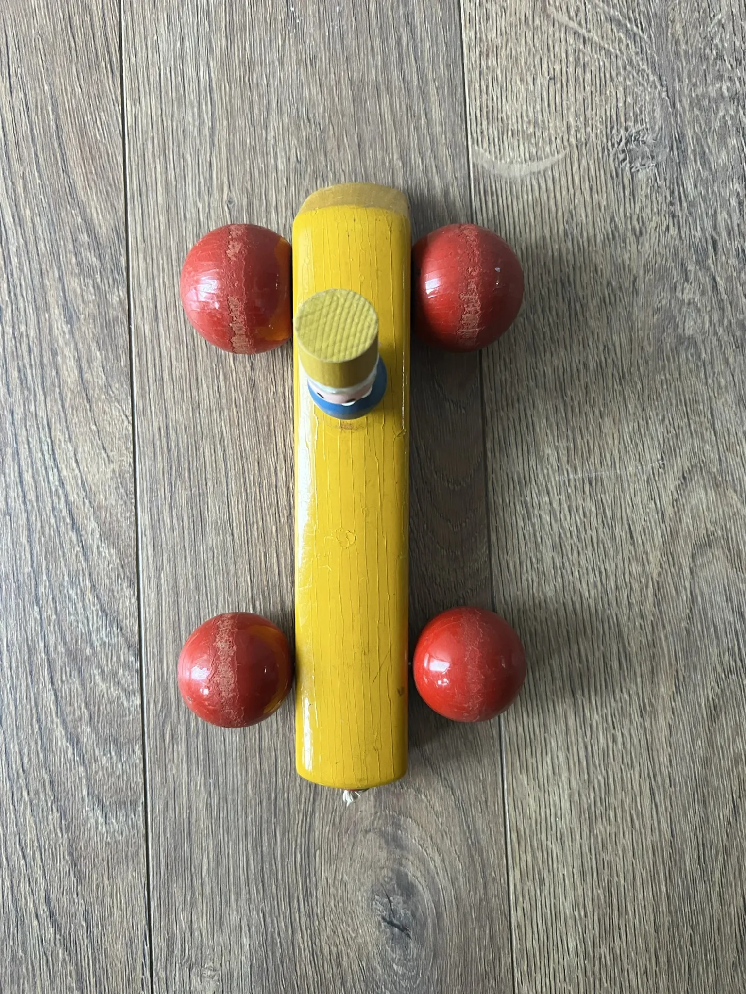Vintage wooden pull toy, yellow car and small soldier.