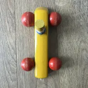 Vintage wooden pull toy, yellow car and small soldier.