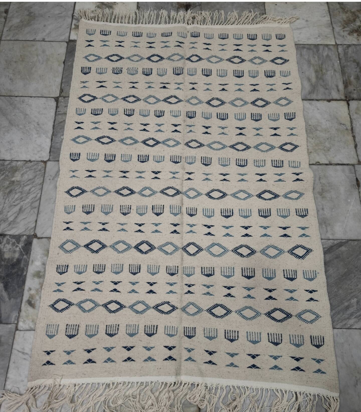 Handmade white and blue rug made of natural wool