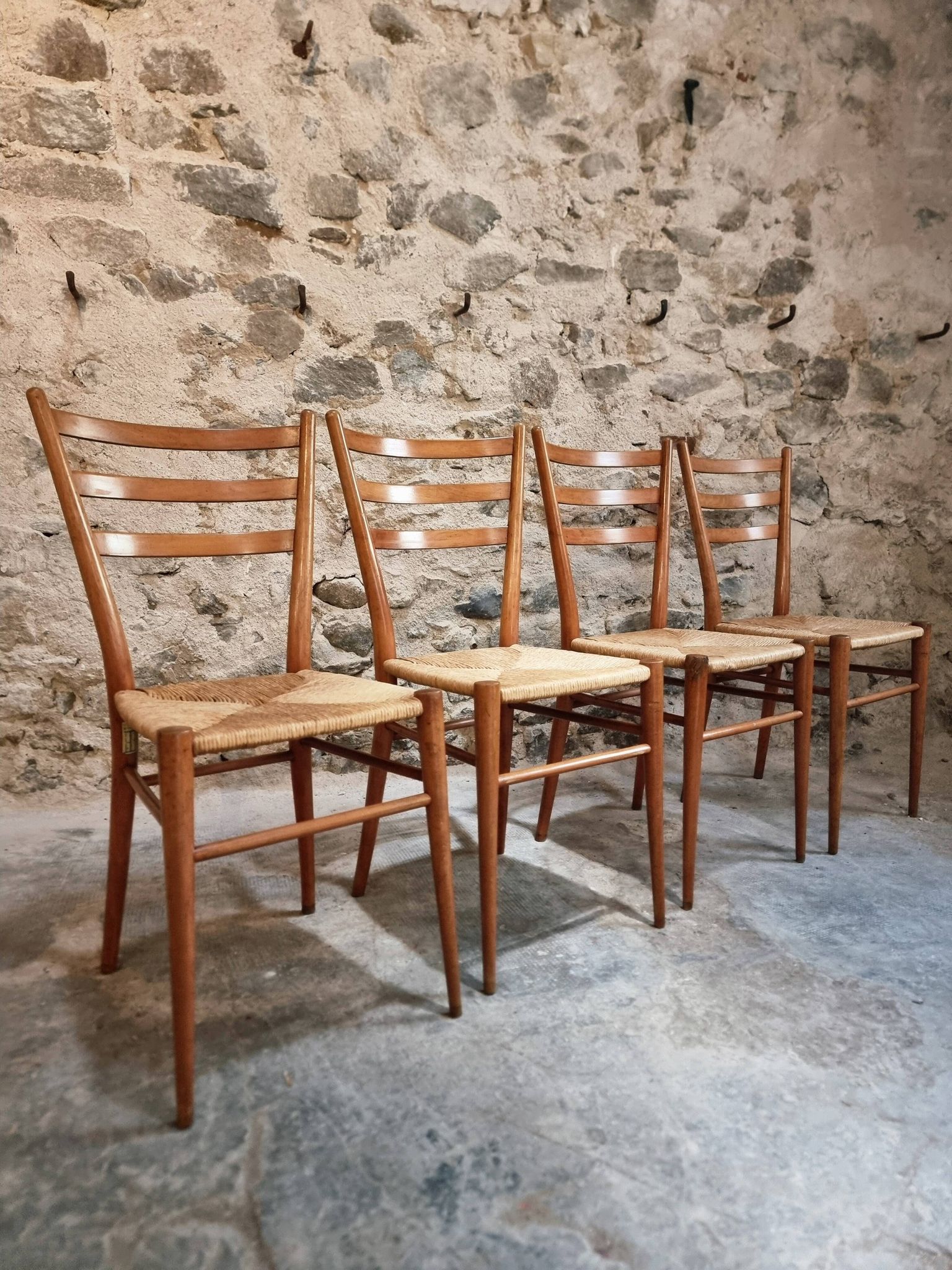 Set of 4 mid-century Italian dining chairs with woven seats, circa 1950–1970.